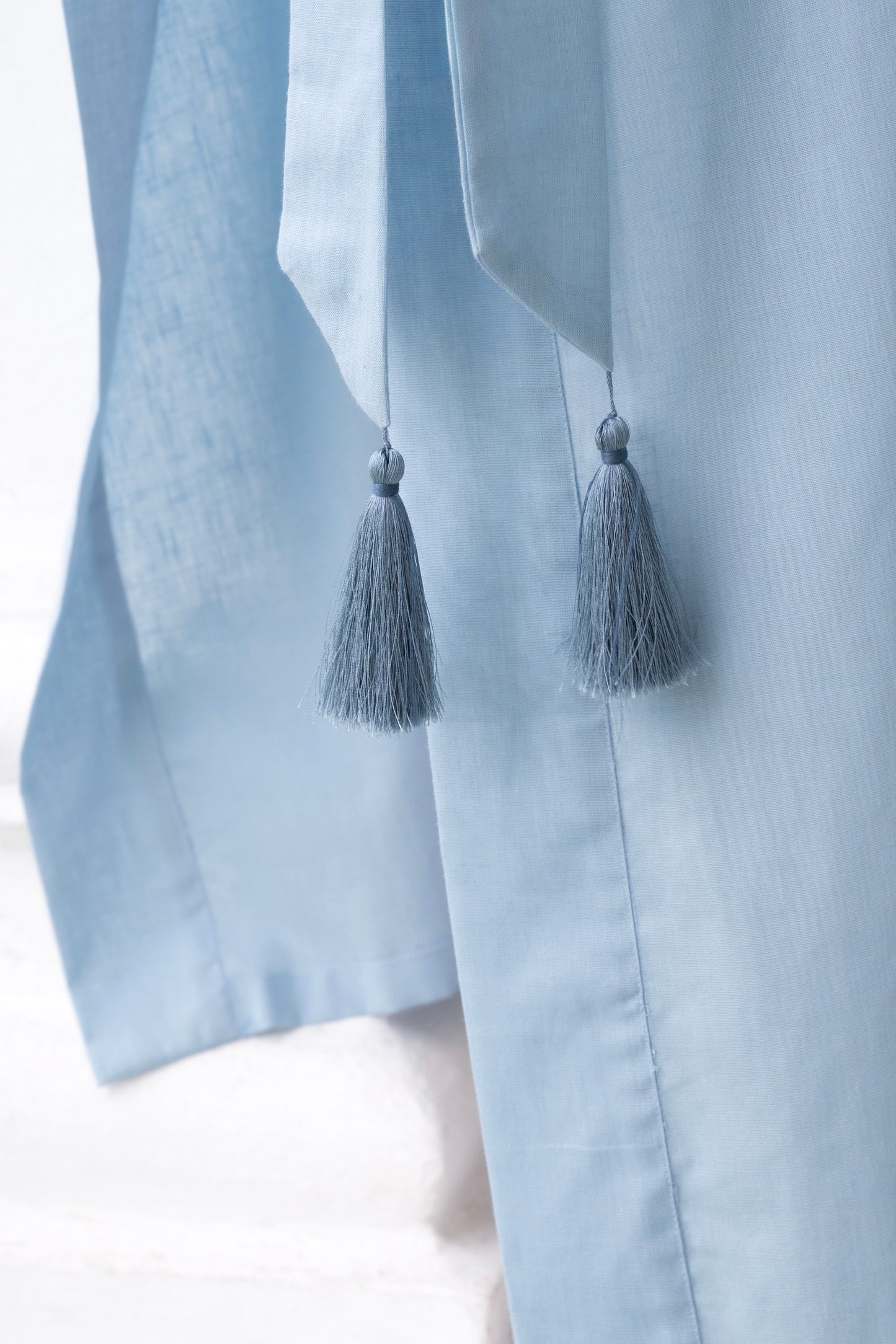 Lyocell linen long kimono in light blue, with belt and tassel, showing tassel detail, women’s loungewear